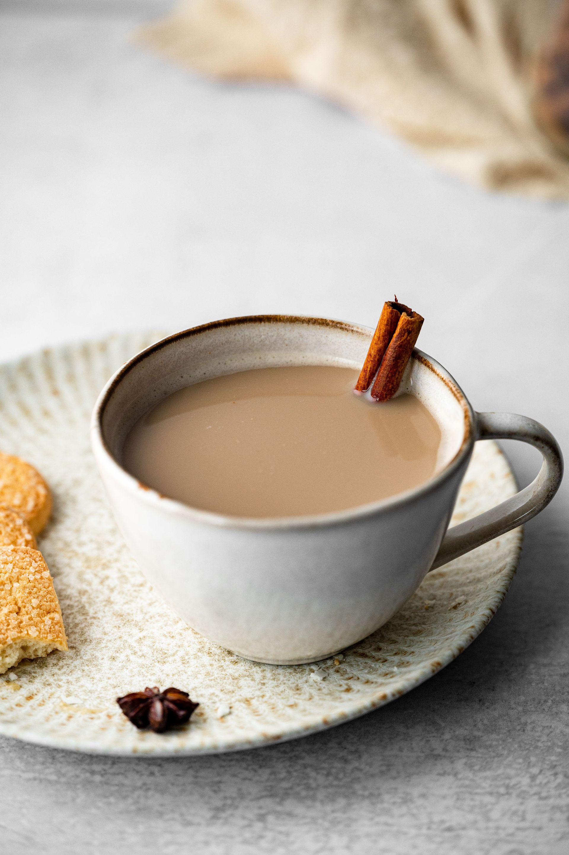 A cozy chai latte served in a ceramic cup with cinnamon stick, perfect for comforting moments.